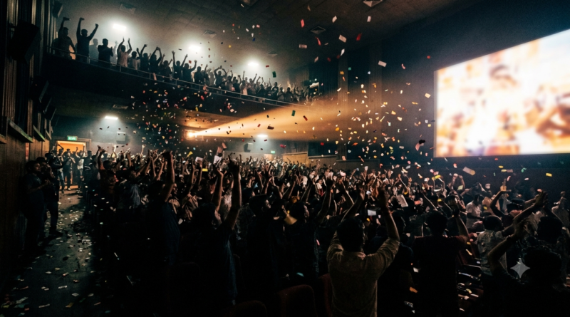 Mass Cinema Telugu fans cheering at a first-day-first-show in a packed single-screen cinema