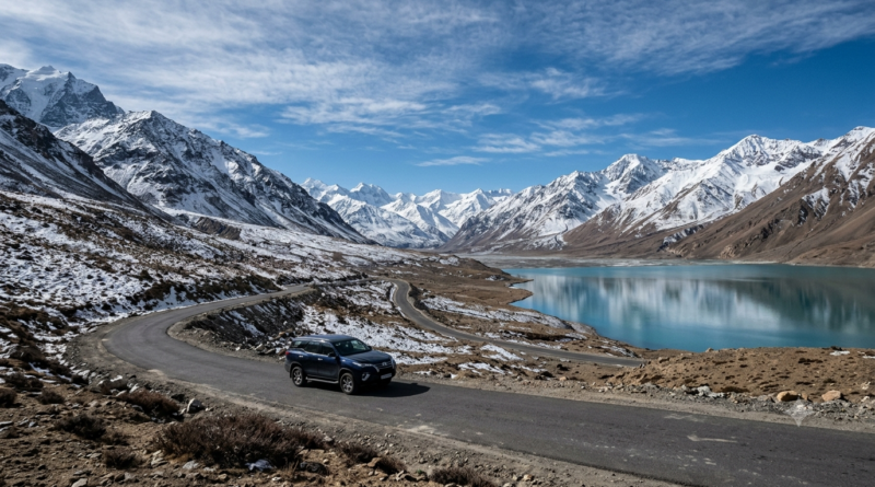 Telugu films exotic locations: a lone car on an empty Ladakh mountain road under snow peaks