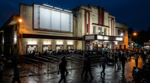 Tollywood box office 2025 rankings: crowd queuing at a Telugu cinema ticket counter at night
